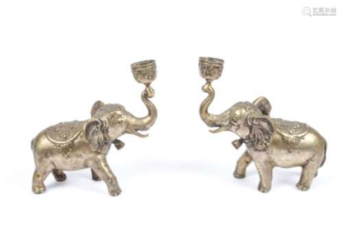 A pair of late 19th Century Anglo Indian cast brass candlesticks, modelled as elephants with