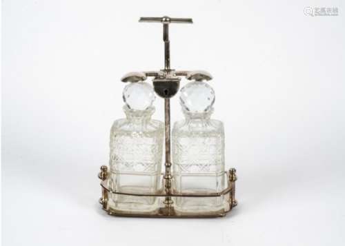 A silver plated two bottle tantalus, with two moulded glass decanters, height 32.5 cm