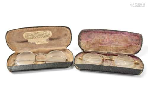 Two cased sets of Edwardian spectacles, a gold coloured metal framed pair, the case marked 