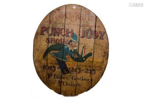 A reproduction advertising sign for 'The Punch and Judy Show', on a wooden oval panel, painted