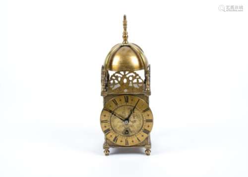 A Victorian 17th Century style brass lantern clock, the circular dial engraved with motifs and