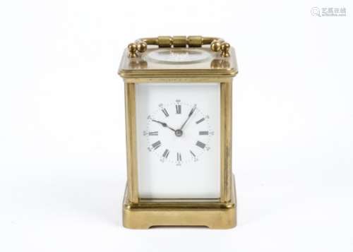 An Early 20th Century carriage clock, white enamel dial with Roman numerals, a brass case with