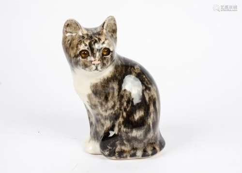 A Winstanley ceramic tabby cat, with orange glass eyes, painted signature to the underside, height