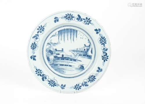 A blue and white English 18th Century tin glazed earthenware 'delftware' charger, with decoration of