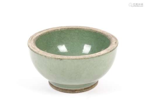 A 19th Century Chinese celadon bowl, of hemispherical shape, the celadon glaze applied in a