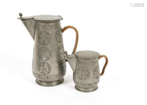 Two Chinese Qing Dynasty pewter jugs and covers, with engraved exteriors and straw work binding to