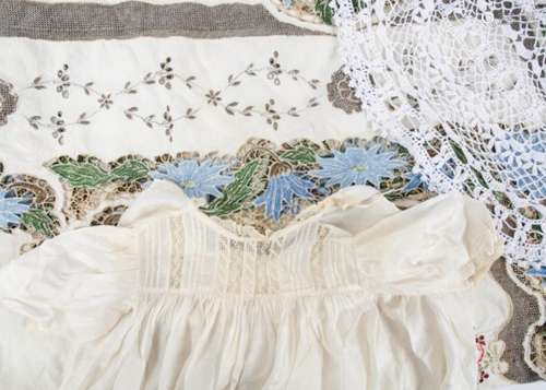 A 20th Century christening robe, with lace around the neckline and hemline, together with a green