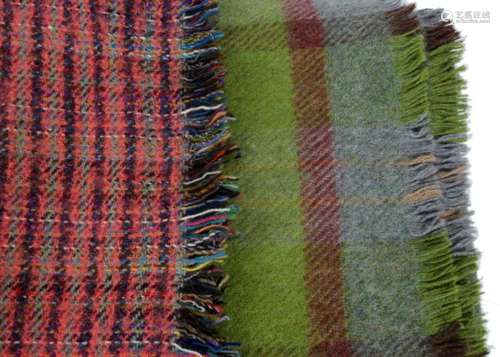 Two 20th Century woollen Welsh type blankets, one with green and red accents with tassels at