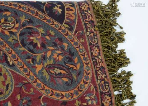 A large paisley shawl, cross woven, with tassel edges, scrolling motifs, approximately 225 cm x