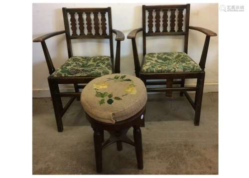 A pair of Ercol arm chairs, stained wood with drop in seats of tapestry upholstery, both with