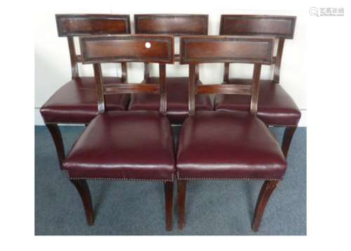 A set of five mahogany dining chairs, upholstered with studded burgundy leather seats, AF