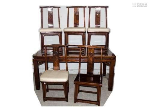 An assembled Chinese hardwood dining room set comprising a dining table, the oblong top with