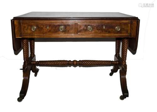 An English Regency mahogany and rosewood cross banded sofa table, the oblong flat top with rounded