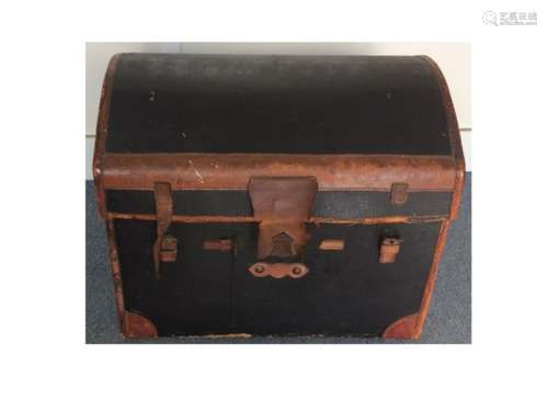 An Early 20th Century travelling trunk, domed structure with leather bindings, lined with an