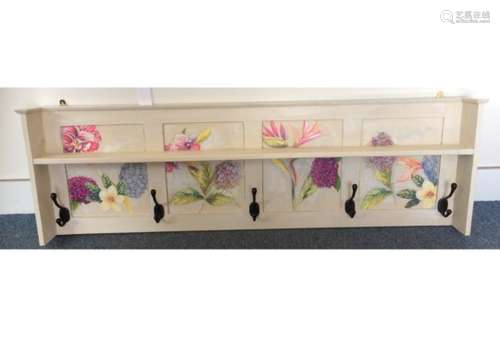 A Mid 20th Century wall mounted oak coat rack, painted with four floral decorated panels and five