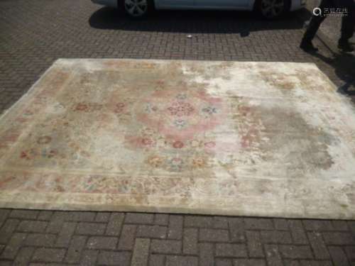 A large Chinese silk carpet, having cream ground with floral decoration, AF, 273 cm x 372 cm faded