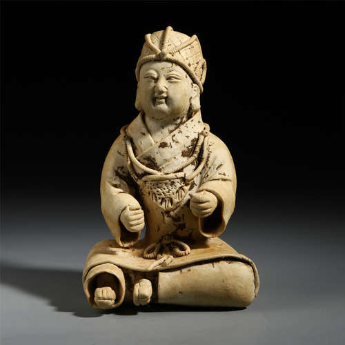 A Chinese White Carved Seated Pottery Figure