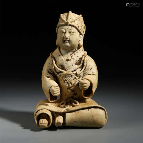 A Chinese White Carved Seated Pottery Figure