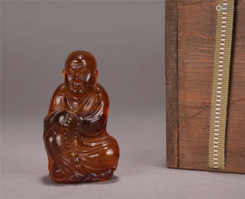 A Chinese Amber Carved Figure of Luohan