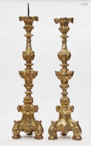 A pair of altar candlesticksItaly, 18th century Hardwood, painted in gold. Restored, bumped, a spout