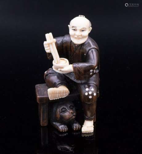 A Fine Carved Ivory and Wood Netsuke of Man Eating…