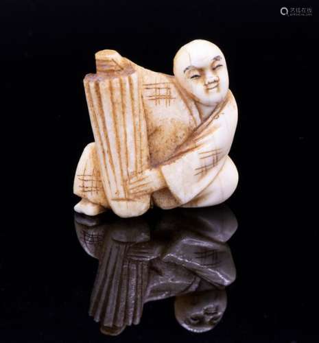 A Carved Ivory Netsuke of a Figure with a Parasol,…