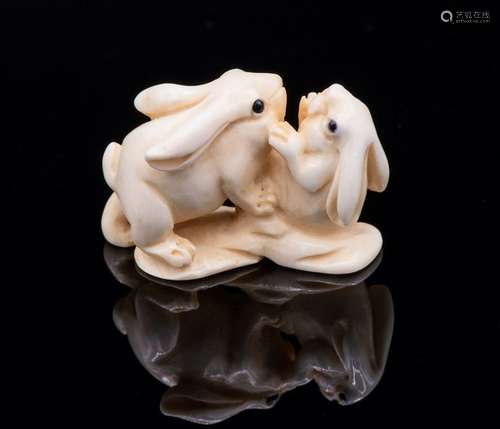 A Fine Carved Ivory Netsuke of Two Hares at Play, …