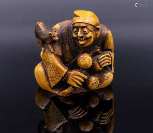 A Carved Stained Ivory Netsuke of Man Playing with…