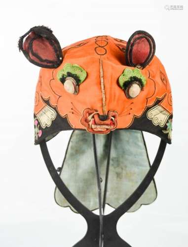 An early 20th century Chinese boy's hat in the form of a tiger to represent protection, worked