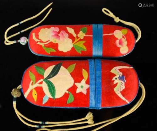 Two Chinese silk applique spectacle cases, circa 1930, both with red silk ground and blue borders,