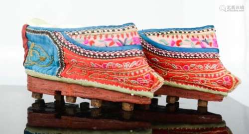 A rare pair of Chinese lotus shoes, circa 1900, with blue and red silk embroidered with floral