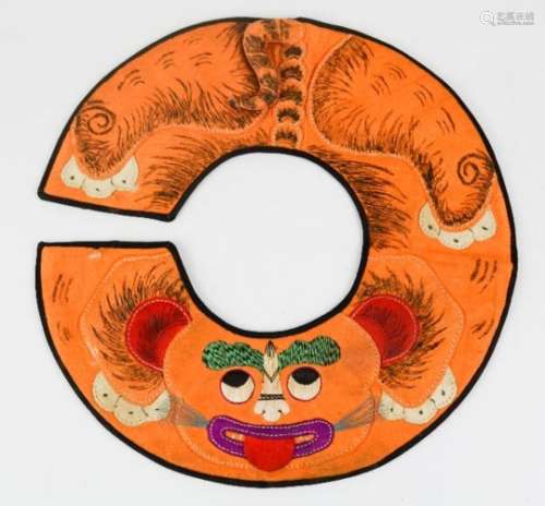 An early 20th century Chinese boys tiger collar, to symbolise protection, embroidered, painted and