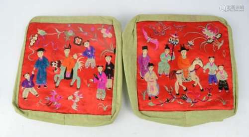 A pair of early 20th century pillow covers, embroidered with Chinese folk embroidery on red