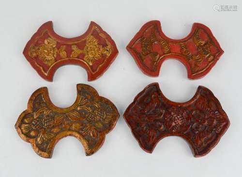 Four 20th century Chinese silk winders, each carved with flowers and painted red. [Featured in