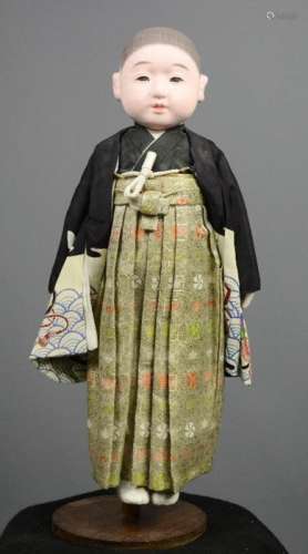 An Ichimatsu doll, late Meiji period (1868-1910), wearing hakama and haori, 49cm long. [Ichimatsu