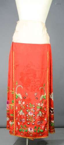 A Chinese embroidered silk wedding skirt in red, circa 1920, intricately embroidered with bats,