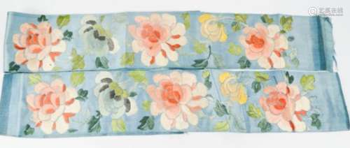 A pair of late 19th century Chinese silk sleeve panels, embroidered with peonies, 72cm long, 8cm