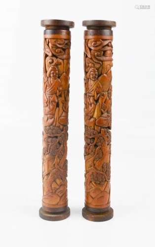 A pair of bamboo carved scroll holders, 20th century, depicting figures in landscape, 23cm high.