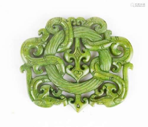 A Chinese heitain natural green jade pendant carved with intertwined dragons.