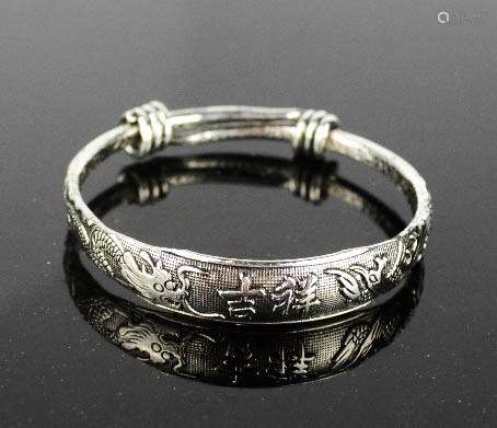 A Tibetan Miau silver carved bangle with dragon design.