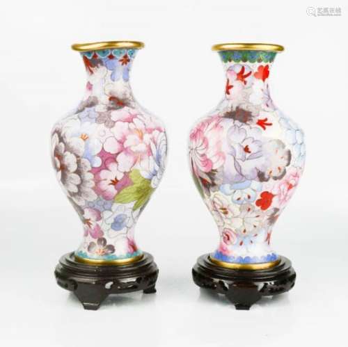 A pair of vintage Chinese cloisonne vases, floral design, on laquered bases, 20cm high.