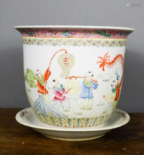 A 20th century Chinese jardiniere depicting a dragon chasing children in a garden, with dish, 24cm