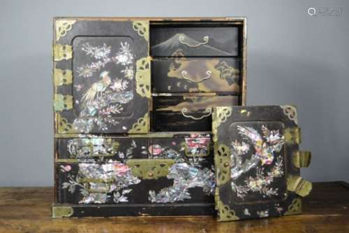 An early 19th century ebonised Chinoiserie decorated cabinet, with mother of pearl inlaid doors,