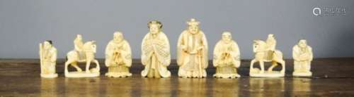 A group of nine 19th century carved ivory chess pieces.