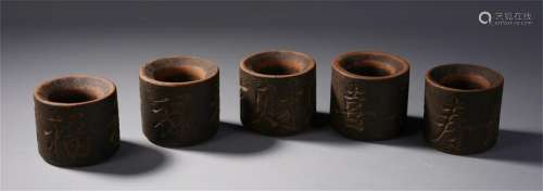 FIVE CHINESE AGALWOOD ARCHER'S RINGS