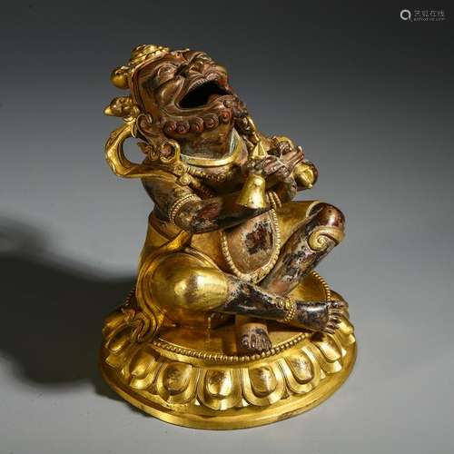 TIBETAN GILT BRONZE SEATED BUDDHIST GUARDIAN