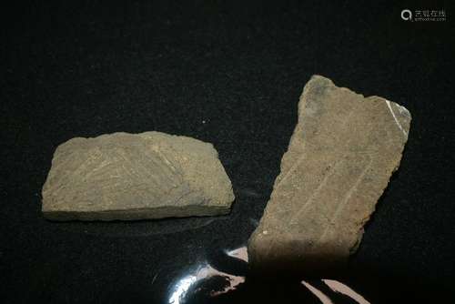 Two pieces of pottery fragments from ancient times