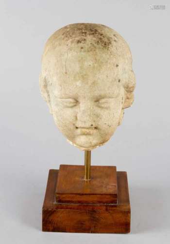 Roman Marble bust of a young boy or child. White marble on later wooden base. Weathered. Possibly