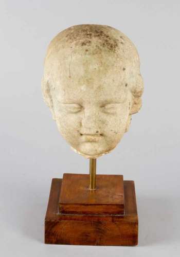 Roman Marble bust of a young boy or child. White marble on later wooden base. Weathered. Possibly