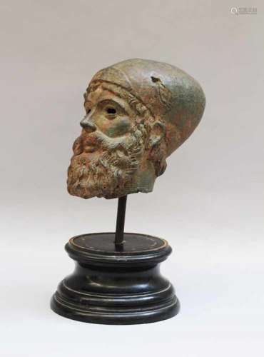 Male Bronze head of a bearded man with hat. Bronze-cast with verdigris and original patina. Eyes